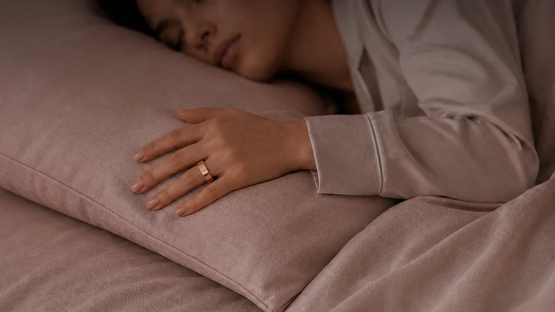 Woman sleeping while wearing Femometer Ring Air